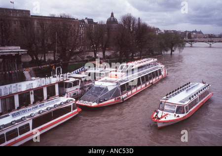 Certains de grenu Moody bateaux mouches bateaux d'excursion sur la Seine à Paris France sur un jour de tempête Banque D'Images