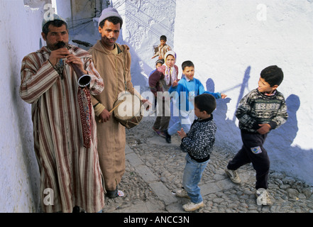 Musiciens portant des djellabas et des enfants à Medina Chechaouen Maroc Banque D'Images