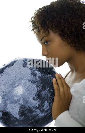 Young woman kissing globe, profil, close-up Banque D'Images