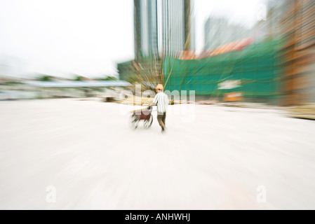 Construction Worker working at construction site, blurred motion Banque D'Images