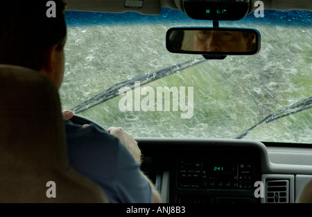 Businessman driving car dans la pluie Banque D'Images