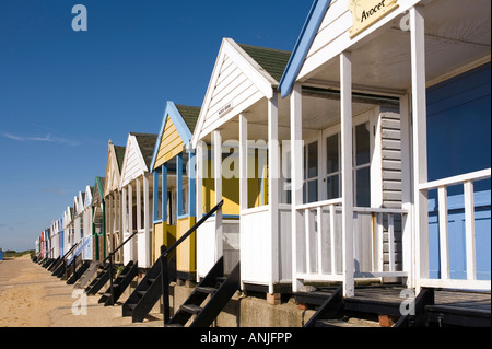 UK Suffolk Southwold front peint de couleurs vives, des cabines de plage sur la promenade au-dessous de Gun Hill Banque D'Images