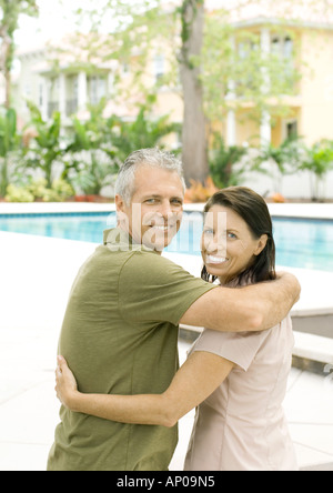 Couple standing in front of pool Banque D'Images
