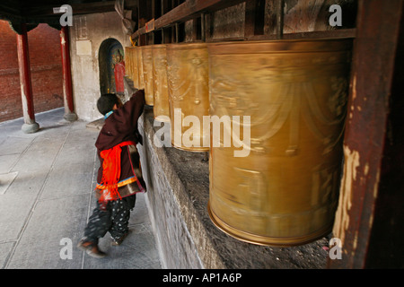 Moine enfant tournant les roues de prière à la base de la Grande Pagode blanche au cours de l'anniversaire pour Tayuan Wenshu, M Banque D'Images