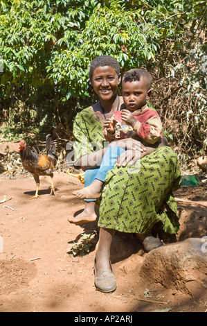 Une femme et son bébé pose devant l'appareil photo dans leur maison près de l'Ura Kidane Mihret - monastère. Banque D'Images
