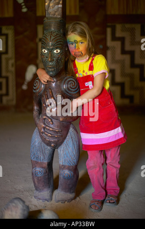 Fille avec facepainting (comme un moko maori, Tatoo), sculpture Maori en Marae, célébrations à Waitangi Day, Okains Bay Mus Banque D'Images