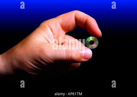 Human hand holding compact disc, digital composite Banque D'Images