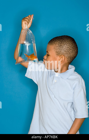 Garçon avec un poisson rouge Banque D'Images