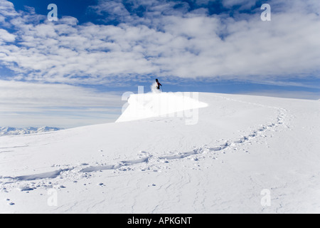 Man with snowboard sur le dos à la raquette dans les montagnes, Autriche Banque D'Images