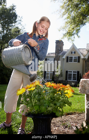 Girl (10-11) arrosage des fleurs, Chatham, New Jersey, USA Banque D'Images