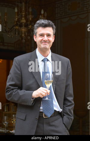 Jean-Marc Lallier-Deutz de la famille Deutz, directeur de la société holding de dégustation d'un verre de champagne à l'extérieur de la salle de dégustation de Champagne Deutz à Aÿ, vallée de la Marne, Champagne, Marne, Ardennes, France Banque D'Images