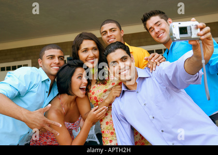 Multi-ethnic friends taking own photograph Banque D'Images