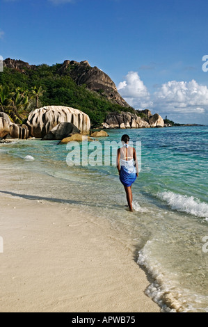 Woman walking on beach parution Modèle Anse Source d'argent beach l'île de La Digue Seychelles Banque D'Images