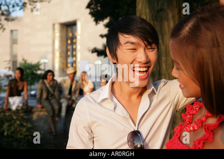 Asian couple outdoors smiling together Banque D'Images