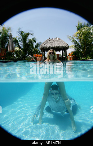 Couple dans une piscine, l'homme dans l'eau Banque D'Images