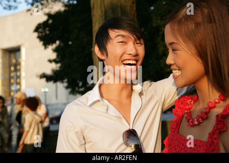 Asian couple outdoors smiling together Banque D'Images