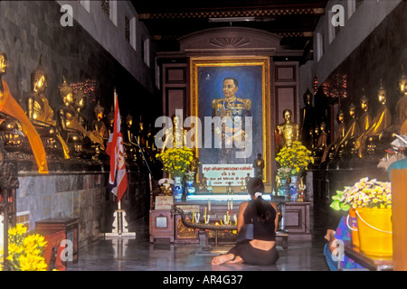 Culte intérieur avec femme fidèle au temple de Wat Po, Bangkok, Thaïlande Banque D'Images