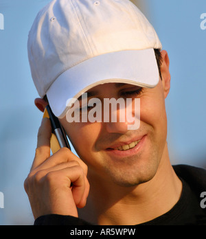 Jeune homme appelant ON CELL PHONE Banque D'Images