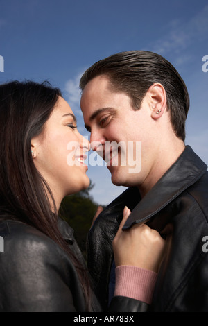 Multi-ethnic couple hugging outdoors Banque D'Images