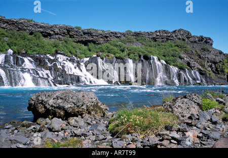 Hraunfossen chute se déversant du dessous de la pierre de lave volcanique en champ bleu magnifique rivière Hvita dans l'ouest de l'Islande Banque D'Images