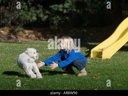 Enfant essayant d'attraper son chien Banque D'Images