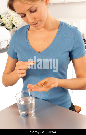 WOMAN TAKING PILLS Banque D'Images