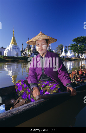 Portrait d'une femme dans un bateau, le port d'un chapeau de paille et le visage coller, Kyaung Phaung Daw U, au Lac Inle, l'État de Shan, Myanmar (Birmanie) Banque D'Images