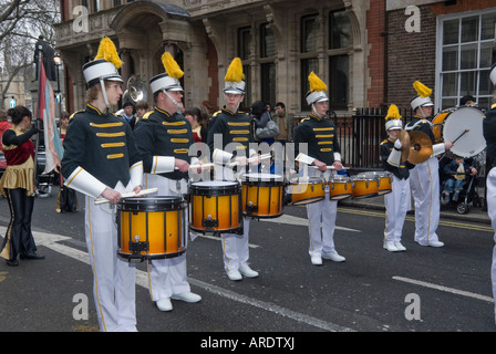 Percussionnistes et un joueur de cymbale a US High School Marching Band line up dans une rue de Londres avant le défilé du Nouvel An. Banque D'Images