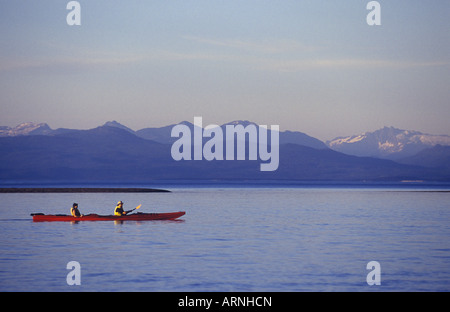 Parksville Beach les pagaies de kayak double sur le détroit de Géorgie. Plage côte à distance en soirée, l'île de Vancouver, Colombie-Britannique, Banque D'Images