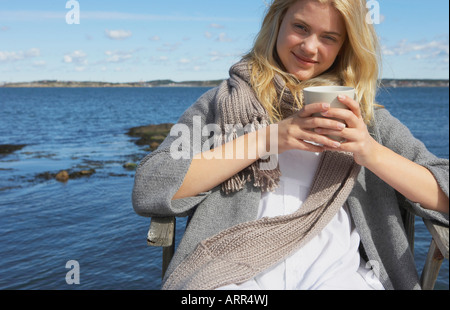 Jeune femme à boire le thé ou café Banque D'Images