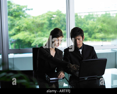 Les gens d'affaires Looking at Laptop Banque D'Images