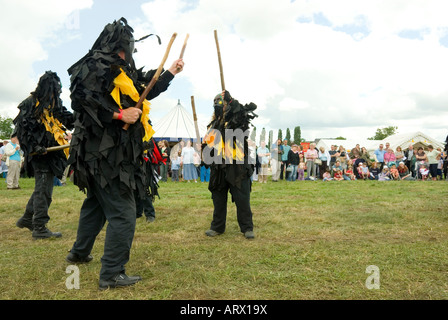 Bedlam Morris Dancers en noir robes Rag lutte danse avec des bâtons en style païennes traditionnelles Tewkesbury Fête médiévale l'Angleterre Banque D'Images