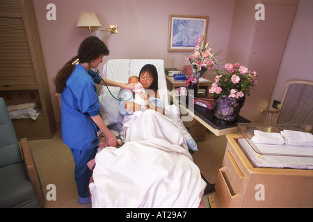 Infirmière ayant tendance à mère et nouveau-né à l'hôpital salle de réveil Banque D'Images