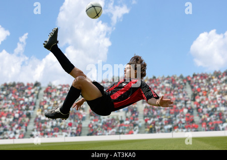 Joueur de football faisant scissor kick Banque D'Images