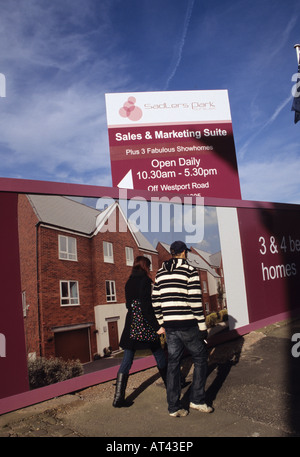 Jeune couple en passant devant de nouveaux logements Burslem Stoke-on-Trent Banque D'Images