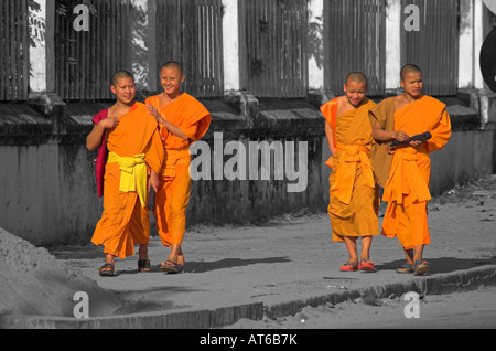 4 jeunes moines marchant dans une rue Banque D'Images