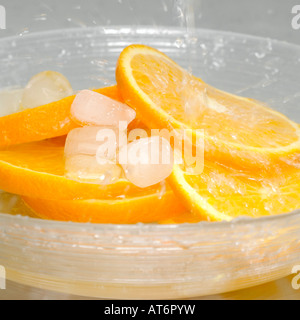 Tranches d'orange avec des cubes de glace dans un bol Banque D'Images