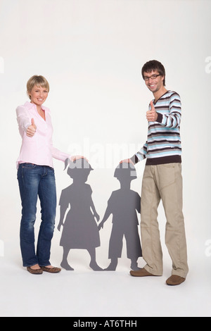 Jeune couple showing Thumbs up sign, portrait Banque D'Images