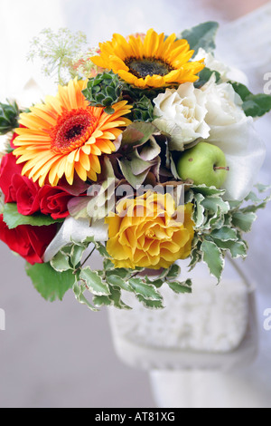 Un portrait d'un bouquet de belles fleurs étant détenu par la promise dans une robe blanche traditionnelle le jour de son mariage Banque D'Images