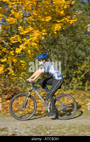 Jeune femme équitation un vélo de montagne à la banque du fleuve Lech près de Koenigsbrunn Bavaria Allemagne Banque D'Images