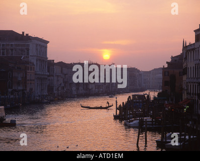 Sur le Grand Canal en gondole à la silhouette au coucher du soleil vu du pont du Rialto Venise Vénétie Italie Banque D'Images