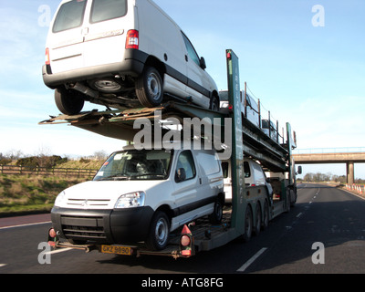 Fourgonnettes blanches à l'arrière d'un véhicule voiture transporter fournis tout au long de l'autoroute en dehors de Belfast Banque D'Images