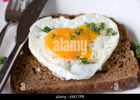 Œuf frit en forme de cœur sur un sandwich Banque D'Images