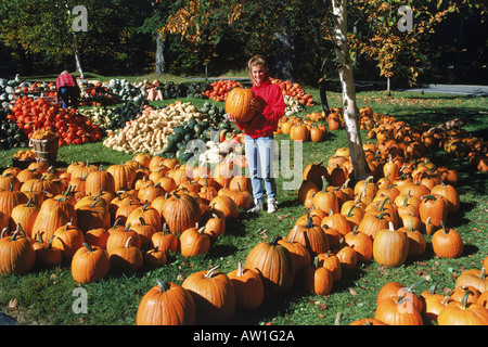 Jeune femme tenant sur la citrouille citrouille et gourd farm en Californie Banque D'Images