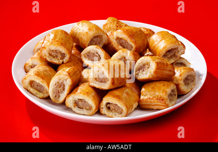 Une assiette de saucisson roule sur un fond rouge. Banque D'Images