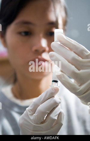 Remplir une seringue avec une infirmière, vaccins clinique Mae Tao pour les réfugiés birmans, Maesot, Thaïlande Banque D'Images