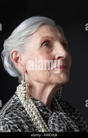 Senior Woman with Pearl Earrings, looking up Banque D'Images