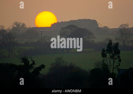 Le soleil s'enfoncer sur les collines qu'il établit des ensembles dans une soirée au-dessus du fleuve de Malpas, Truro, Cornwall Banque D'Images