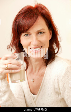 Femme d'âge moyen de boire un café latté Banque D'Images