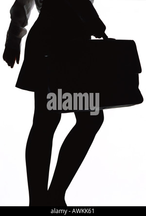 Woman walking with briefcase, silhouette. Banque D'Images